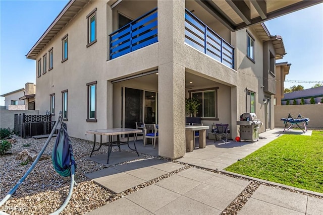 12332 Switchgrass Ave, Las Vegas, NV 89138 - back of house featuring stucco siding, a patio area, and a balcony