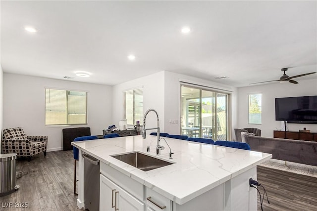 12332 Switchgrass Ave, Las Vegas, NV 89138 - kitchen with open floor plan, a sink, wood finished floors, white cabinets, and recessed lighting