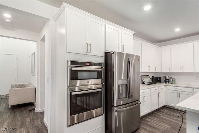 12332 Switchgrass Ave, Las Vegas, NV 89138 - kitchen featuring stainless steel appliances, dark wood-type flooring, white cabinetry, and recessed lighting