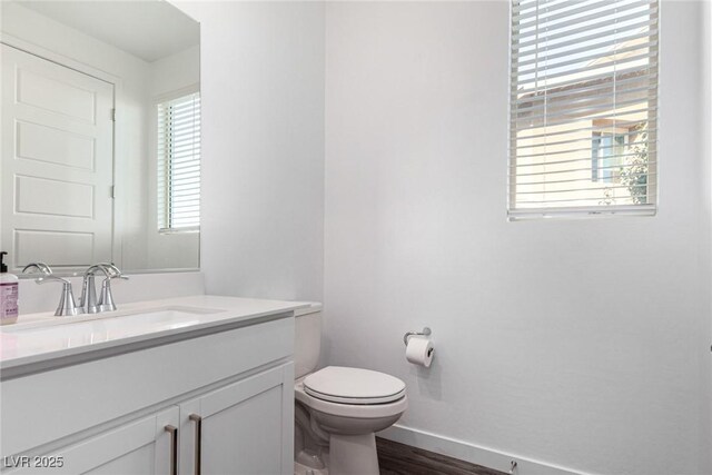 12332 Switchgrass Ave, Las Vegas, NV 89138 - bathroom featuring vanity, toilet, baseboards, and wood finished floors