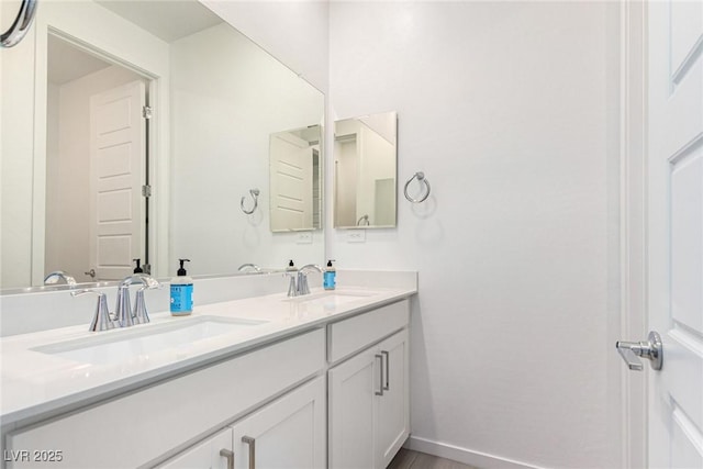 12332 Switchgrass Ave, Las Vegas, NV 89138 - bathroom with double vanity, baseboards, and wood finished floors