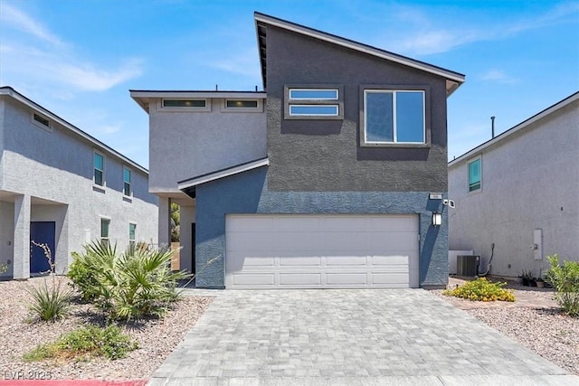66 Chelsea Manor Ct, Las Vegas, NV 89110 - view of front of home with stucco siding, a garage, decorative driveway, and central AC unit
