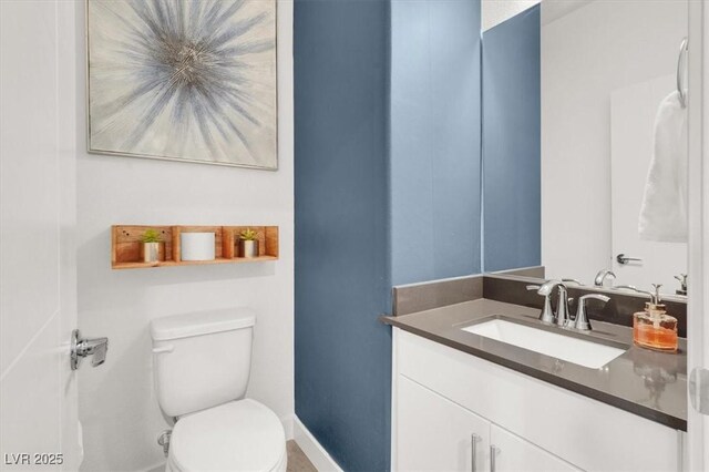 66 Chelsea Manor Ct, Las Vegas, NV 89110 - bathroom featuring toilet, vanity, and baseboards