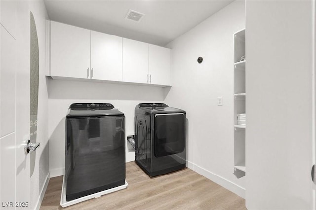66 Chelsea Manor Ct, Las Vegas, NV 89110 - washroom featuring separate washer and dryer, cabinet space, light wood finished floors, and baseboards