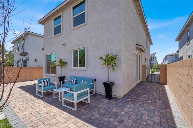 66 Chelsea Manor Ct, Las Vegas, NV 89110 - rear view of property with stucco siding, a fenced backyard, an outdoor living space, and a patio