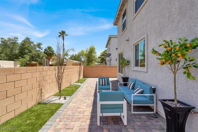 66 Chelsea Manor Ct, Las Vegas, NV 89110 - fenced backyard featuring outdoor lounge area and a patio