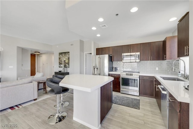 8255 Las Vegas Blvd Unit 1821, Las Vegas, NV 89123 - kitchen featuring stainless steel appliances, a sink, a kitchen island, open floor plan, and light countertops