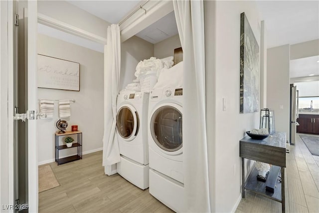 8255 Las Vegas Blvd Unit 1821, Las Vegas, NV 89123 - laundry room with separate washer and dryer, light wood-type flooring, and baseboards