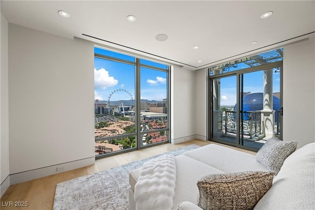1 Hughes Center Dr Unit 1901, Las Vegas, NV 89169 - bedroom featuring floor to ceiling windows, wood finished floors, access to exterior, and recessed lighting