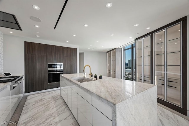 1 Hughes Center Dr Unit 1901, Las Vegas, NV 89169 - kitchen with modern cabinets, a sink, appliances with stainless steel finishes, light marble finish flooring, and recessed lighting