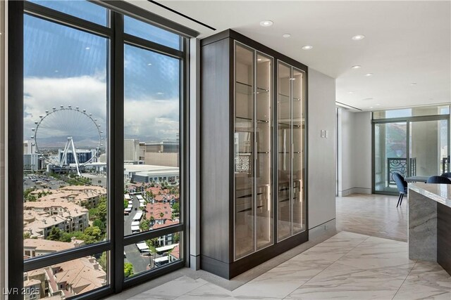1 Hughes Center Dr Unit 1901, Las Vegas, NV 89169 - doorway with floor to ceiling windows, light marble finish floors, recessed lighting, and a view of city