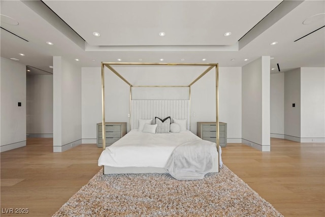 1 Hughes Center Dr Unit 1901, Las Vegas, NV 89169 - bedroom featuring wood finished floors, recessed lighting, baseboards, and a tray ceiling