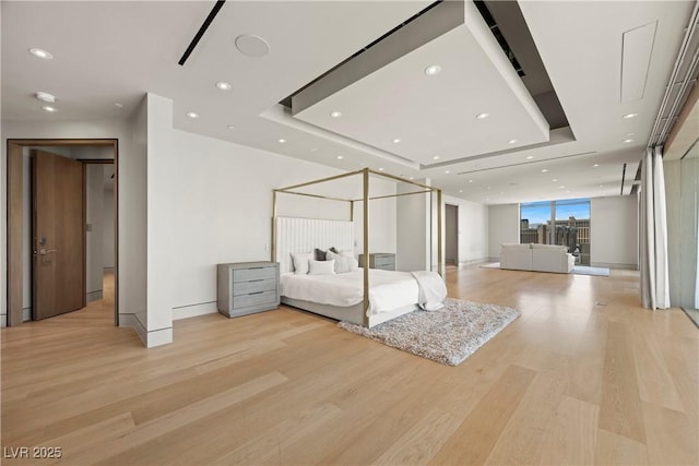 1 Hughes Center Dr Unit 1901, Las Vegas, NV 89169 - bedroom featuring a tray ceiling, light wood-style flooring, recessed lighting, and baseboards