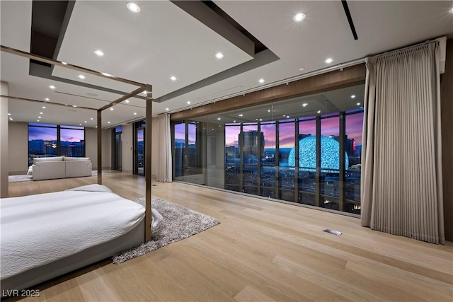 1 Hughes Center Dr Unit 1901, Las Vegas, NV 89169 - bedroom featuring wood finished floors, a wall of windows, recessed lighting, and a raised ceiling