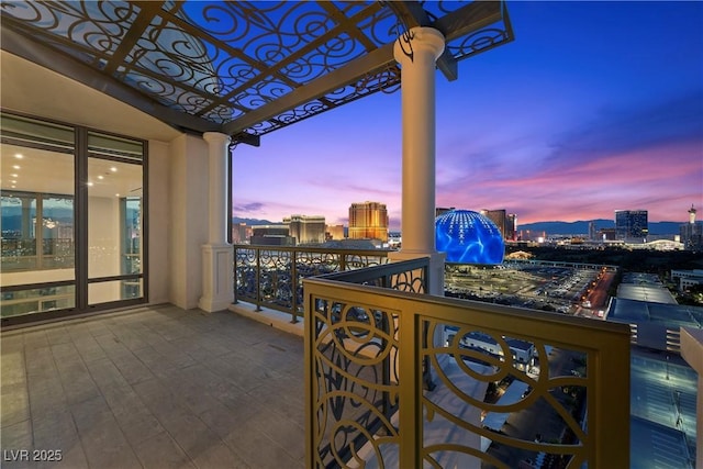 1 Hughes Center Dr Unit 1901, Las Vegas, NV 89169 - balcony at dusk featuring a view of city