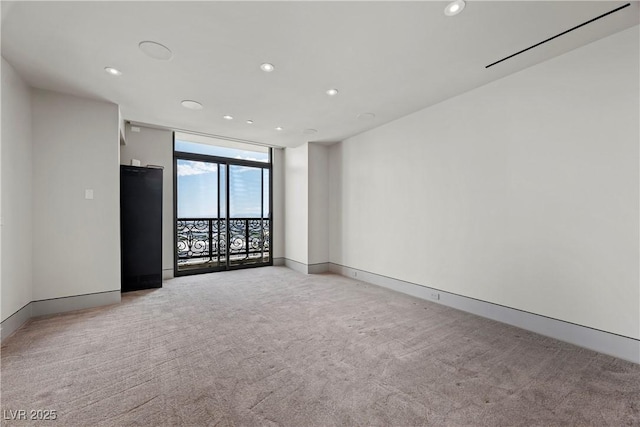 1 Hughes Center Dr Unit 1901, Las Vegas, NV 89169 - spare room featuring recessed lighting, light carpet, baseboards, and a wall of windows