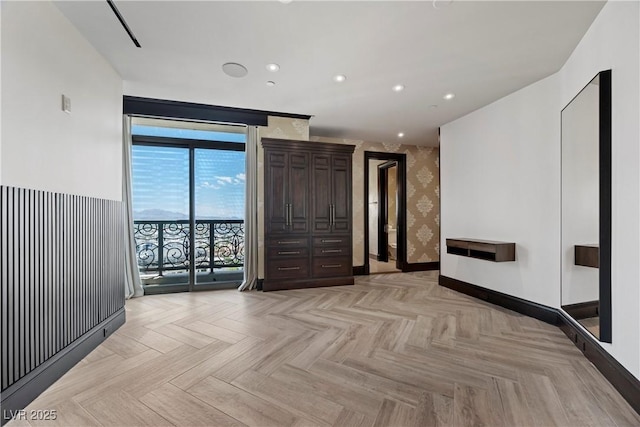 1 Hughes Center Dr Unit 1901, Las Vegas, NV 89169 - unfurnished living room with wallpapered walls, baseboards, and recessed lighting