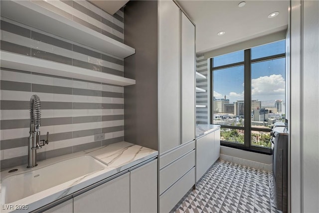 1 Hughes Center Dr Unit 1901, Las Vegas, NV 89169 - bathroom featuring a sink, decorative backsplash, recessed lighting, and a view of city