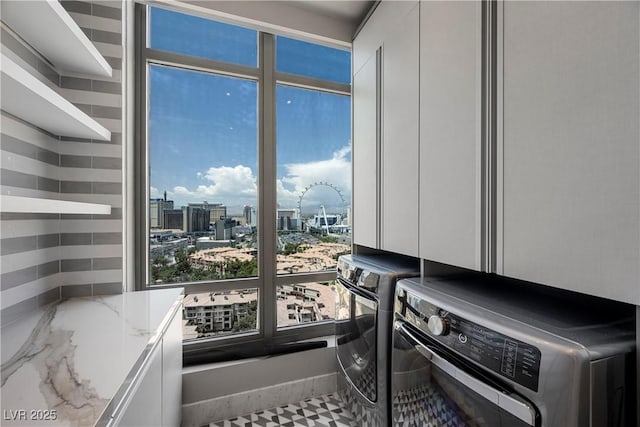 1 Hughes Center Dr Unit 1901, Las Vegas, NV 89169 - washroom featuring washing machine and clothes dryer, a city view, and cabinet space