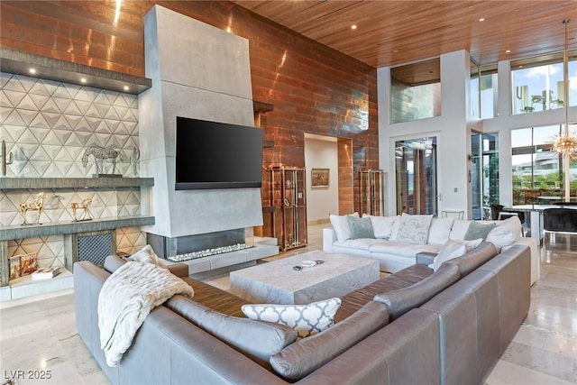 8 Meadowhawk Ln, Las Vegas, NV 89135 - living area featuring wooden ceiling, a high ceiling, a fireplace with raised hearth, and recessed lighting
