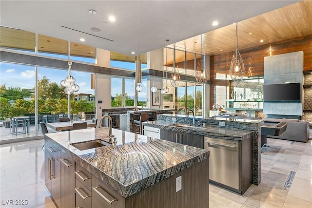 8 Meadowhawk Ln, Las Vegas, NV 89135 - kitchen with a kitchen island with sink, a sink, a chandelier, dishwasher, and recessed lighting