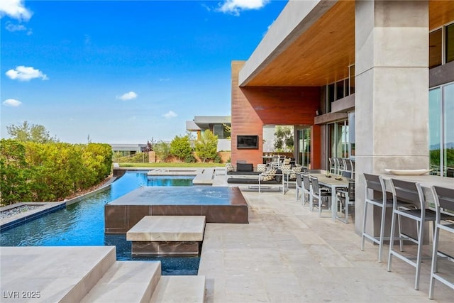 8 Meadowhawk Ln, Las Vegas, NV 89135 - view of pool with a patio area, an infinity pool, an outdoor living space with a fireplace, an outdoor bar, and a hot tub