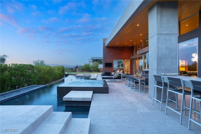 8 Meadowhawk Ln, Las Vegas, NV 89135 - view of swimming pool featuring an outdoor hangout area, a patio, and a hot tub