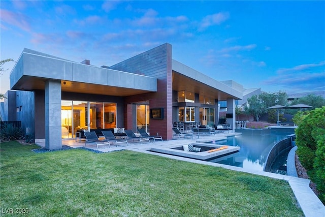 8 Meadowhawk Ln, Las Vegas, NV 89135 - back of house at dusk with a patio area, a lawn, an infinity pool, and a hot tub