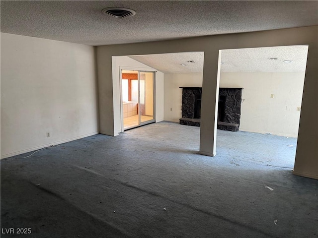 1674 Seneca Ln, Las Vegas, NV 89169 - unfurnished living room featuring carpet flooring, a fireplace, and a textured ceiling