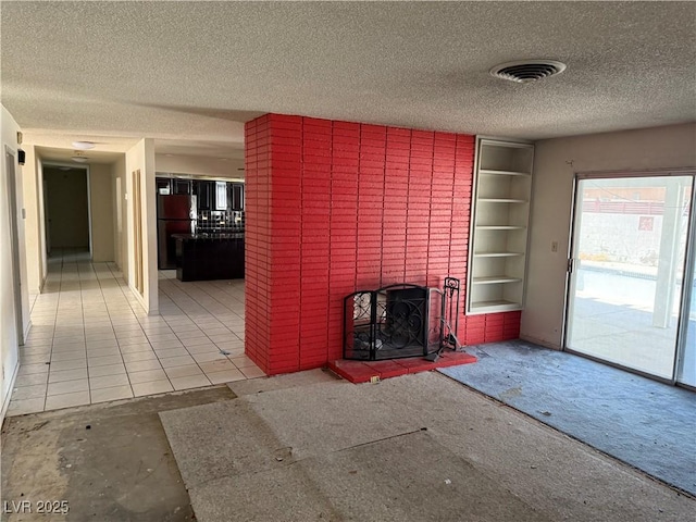 1674 Seneca Ln, Las Vegas, NV 89169 - unfurnished living room featuring a textured ceiling, a brick fireplace, and carpet flooring