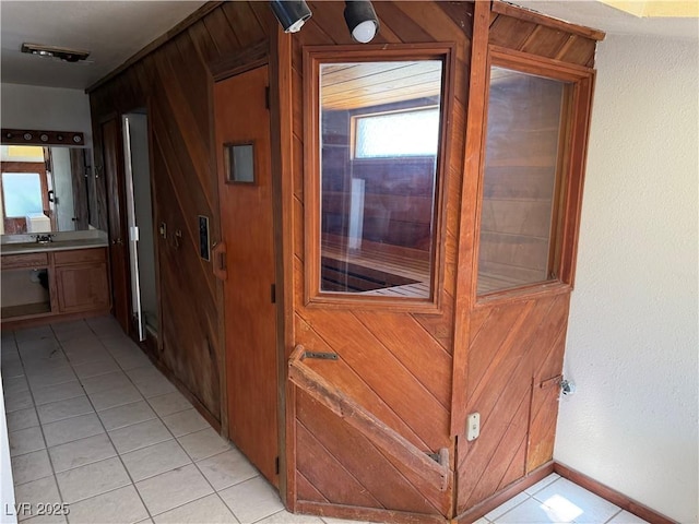 1674 Seneca Ln, Las Vegas, NV 89169 - corridor with light tile patterned floors, a sink, and baseboards