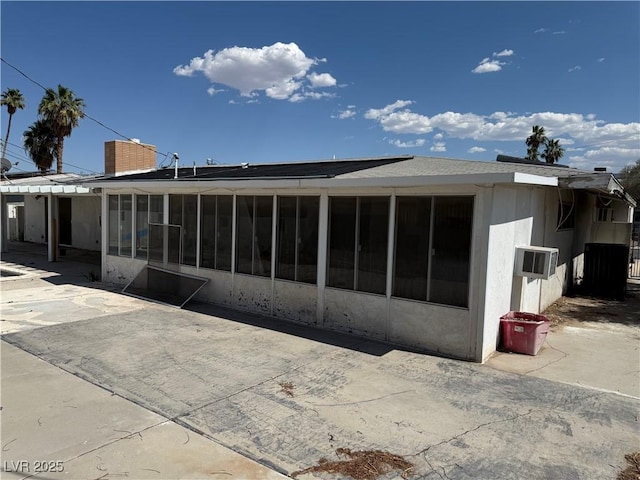 1674 Seneca Ln, Las Vegas, NV 89169 - back of house featuring a sunroom and a chimney
