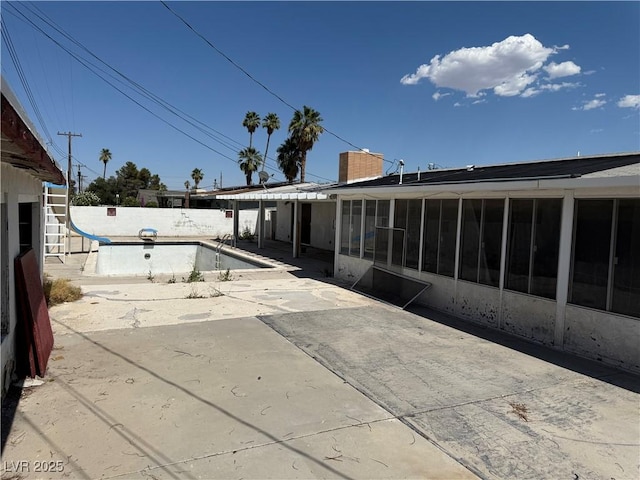 1674 Seneca Ln, Las Vegas, NV 89169 - back of house with a patio area, a sunroom, and a chimney