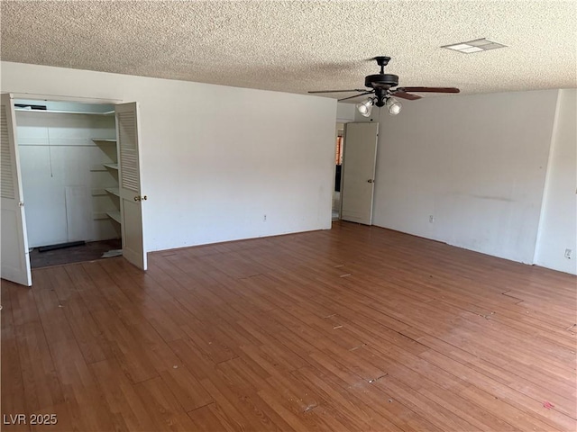 1674 Seneca Ln, Las Vegas, NV 89169 - empty room featuring hardwood / wood-style flooring, a ceiling fan, and a textured ceiling