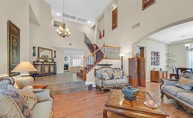 10001 Blairwood Ct, Las Vegas, NV 89178 - living area featuring a chandelier, arched walkways, healthy amount of natural light, a high ceiling, and recessed lighting