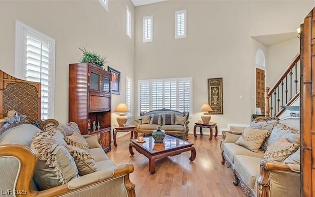 10001 Blairwood Ct, Las Vegas, NV 89178 - living area featuring a towering ceiling, wood finished floors, and stairs