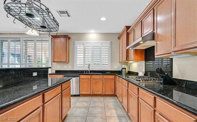 10001 Blairwood Ct, Las Vegas, NV 89178 - kitchen with appliances with stainless steel finishes, under cabinet range hood, a sink, backsplash, and light tile patterned flooring