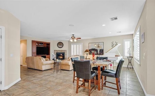 10001 Blairwood Ct, Las Vegas, NV 89178 - dining area featuring plenty of natural light, a ceiling fan, a glass covered fireplace, and baseboards