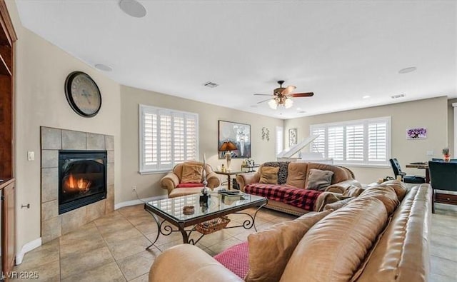 10001 Blairwood Ct, Las Vegas, NV 89178 - living area with ceiling fan, a fireplace, baseboards, and light tile patterned floors