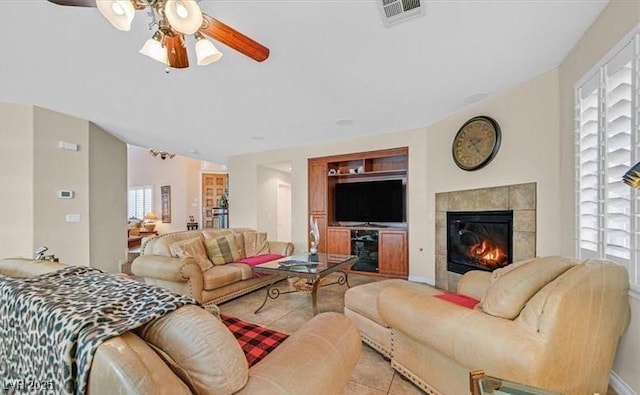 10001 Blairwood Ct, Las Vegas, NV 89178 - living room featuring ceiling fan, a tile fireplace, and baseboards