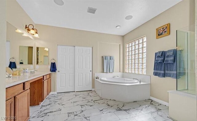 10001 Blairwood Ct, Las Vegas, NV 89178 - bathroom featuring marble finish floors, a garden tub, vanity, and baseboards