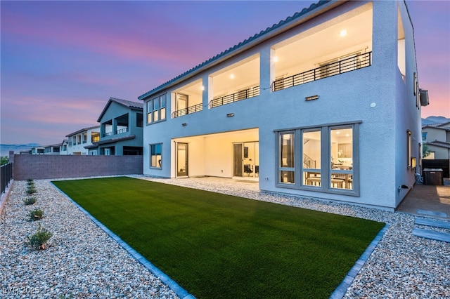 230 Cactus Sunrise St, Las Vegas, NV 89138 - back of house at dusk featuring stucco siding, a balcony, a patio area, and a tile roof