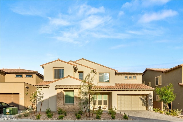 230 Cactus Sunrise St, Las Vegas, NV 89138 - view of front of home featuring driveway, stucco siding, a tile roof, and a garage