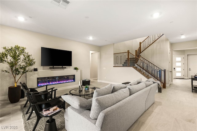 230 Cactus Sunrise St, Las Vegas, NV 89138 - living area with a glass covered fireplace, recessed lighting, baseboards, stairs, and light tile patterned flooring