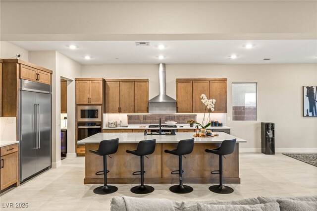 230 Cactus Sunrise St, Las Vegas, NV 89138 - kitchen with built in appliances, wall chimney exhaust hood, decorative backsplash, a breakfast bar, and recessed lighting