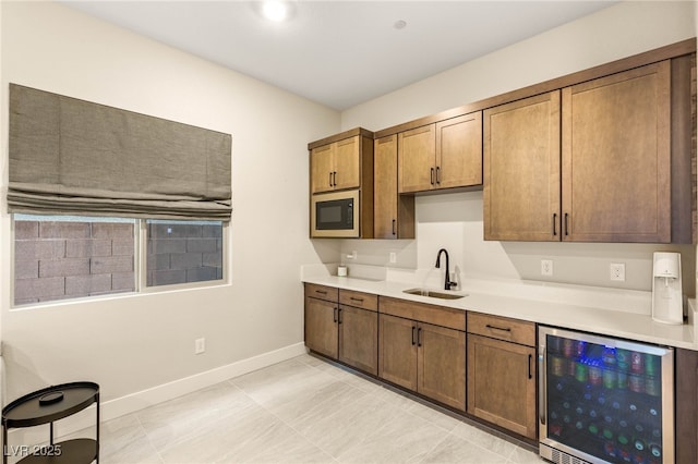 230 Cactus Sunrise St, Las Vegas, NV 89138 - kitchen featuring a sink, built in microwave, wine cooler, baseboards, and light countertops