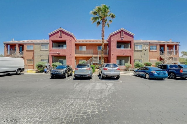 4730 E Craig Rd Unit 1005, Las Vegas, NV 89115 - view of property featuring uncovered parking and stairs