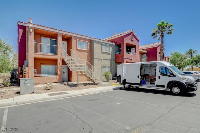 4730 E Craig Rd Unit 1005, Las Vegas, NV 89115 - view of property featuring stairs and uncovered parking