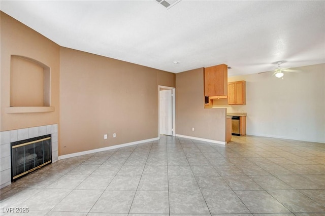 4730 E Craig Rd Unit 1005, Las Vegas, NV 89115 - unfurnished living room featuring a ceiling fan, light tile patterned floors, and a tile fireplace