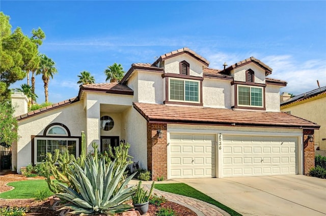 2036 Deer Springs Dr, Henderson, NV 89074 - view of front of house featuring concrete driveway, stucco siding, a garage, brick siding, and a tiled roof